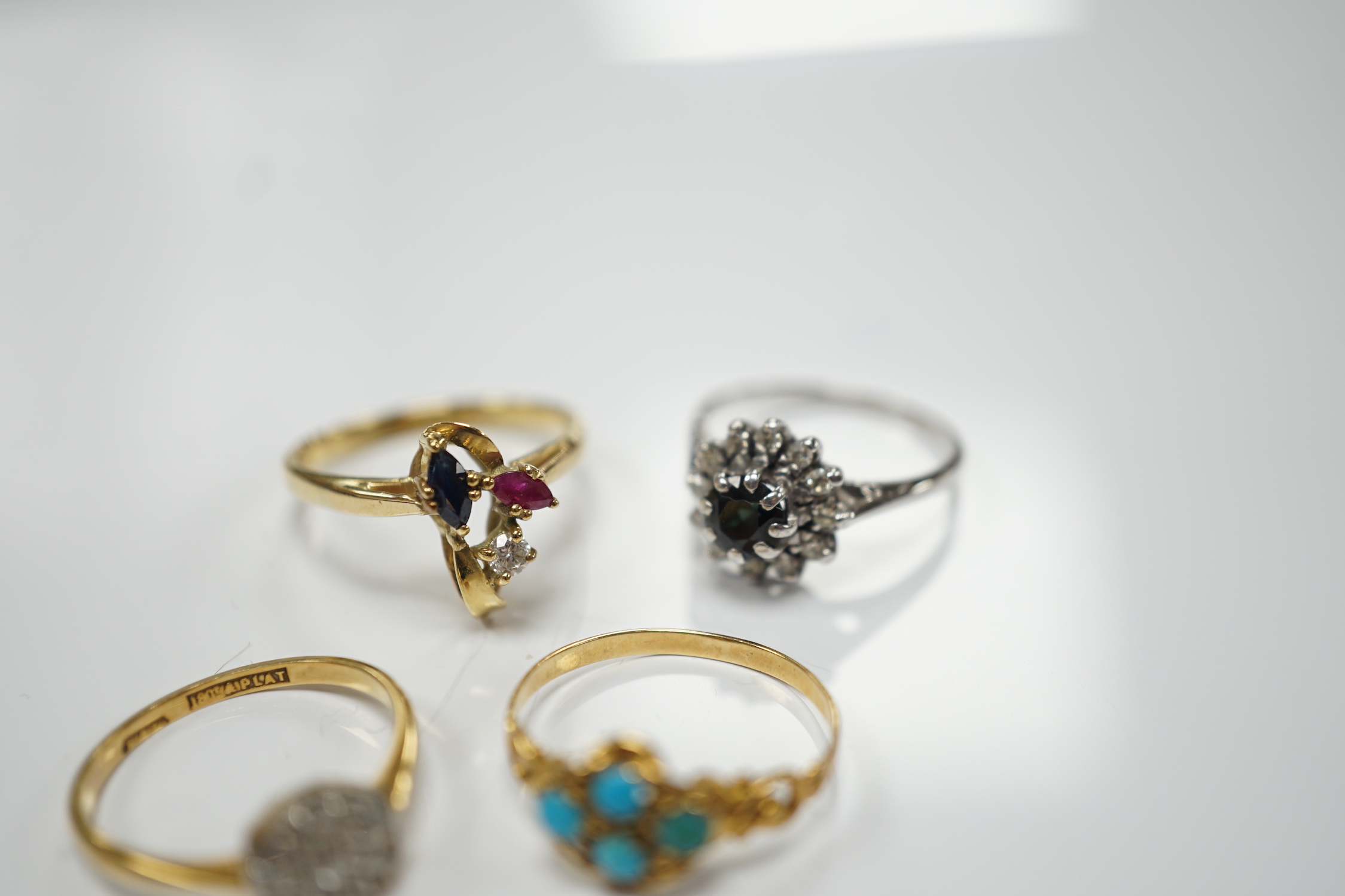 Three assorted 18ct and gem set rings, including 1920's diamond cluster, size K/L, one other early 20th century yellow metal and turquoise cluster set ring and a 15ct, diamond and seed pearl set three stone bar brooch.